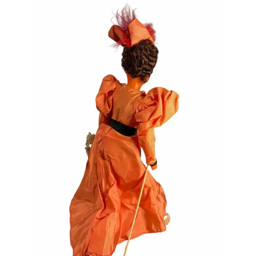 Doll The doll's attire, with its prominent 